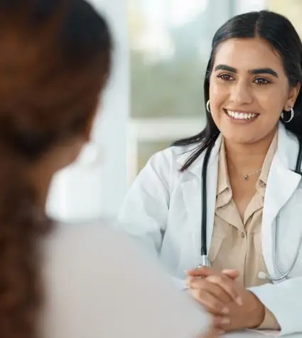 A happy doctor consulting patient for Brazilian butt lift candidacy